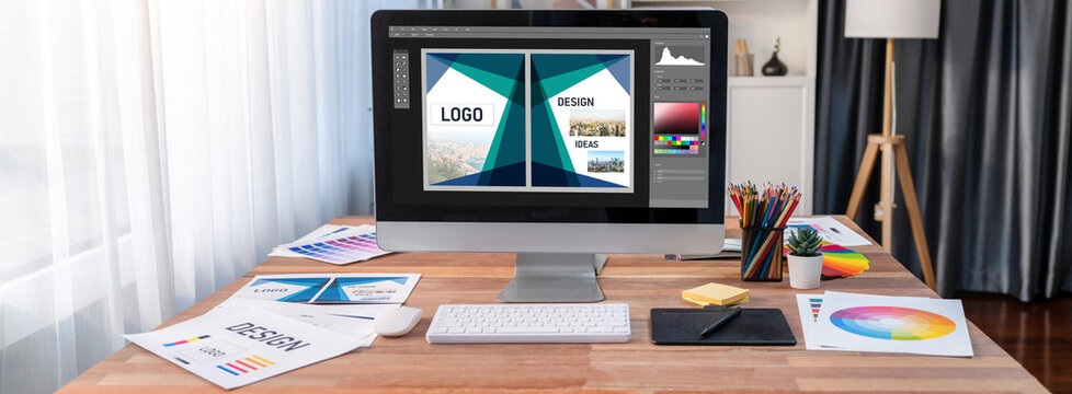 Graphic designer software for modern design of web page and commercial brisk ads showing on the computer screen