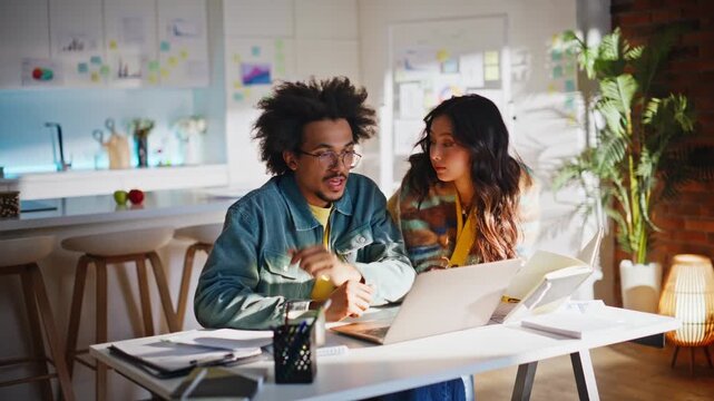 Freelancer team reading documents home office. Multiethnic partners discussing.