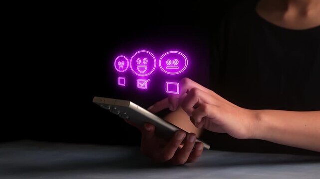 Person tapping smartphone display to select happy face satisfaction icon