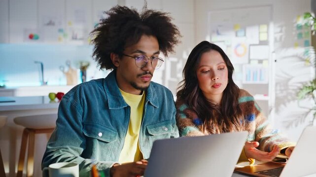 Coworker team planning project two laptops home office. Multiracial startup.