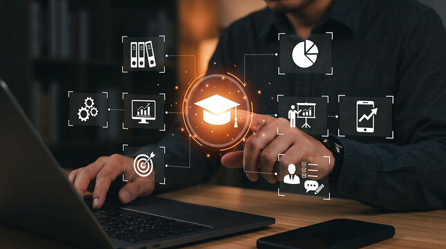 Professional using laptop with glowing education and e-learning digital icons