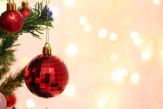 Red christmas tree ornament bauble decoration brings festive cheerful light and golden bokeh holiday warmth to pine branch seasonal celebration scene for happy merry december gathering
