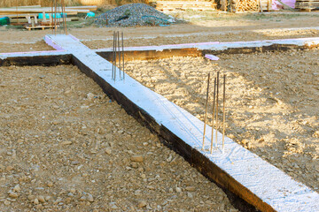 Fototapeta na wymiar Workers prepare building foundation with rebar, concrete in construction site
