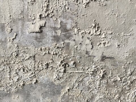 Close-up view of a severely damaged and peeling wall surface, showing signs of wear and neglect.