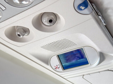 Airplane Cabin Overhead Panel with Arrival Information Screen and Air Vents &ndash; Aviation Interior Detail