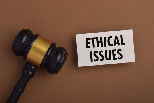 Legal gavel beside an ethical issues sign, representing law, justice, professional ethics, moral dilemmas, legal responsibility, and decision making.