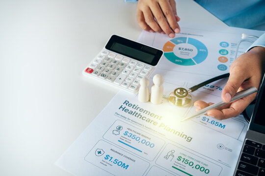 Financial planner working on retirement healthcare planning document with calculator, stethoscope, and wooden figures on white desk, concept of retirement planning and healthcare insurance.