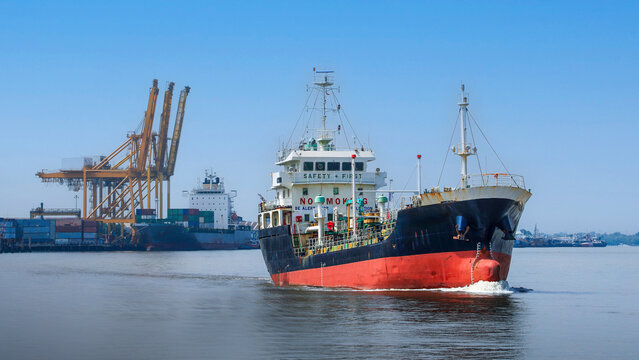 Proud oil tanker navigating calm harbor port water supporting global trade shipping supply chain network under clear sky