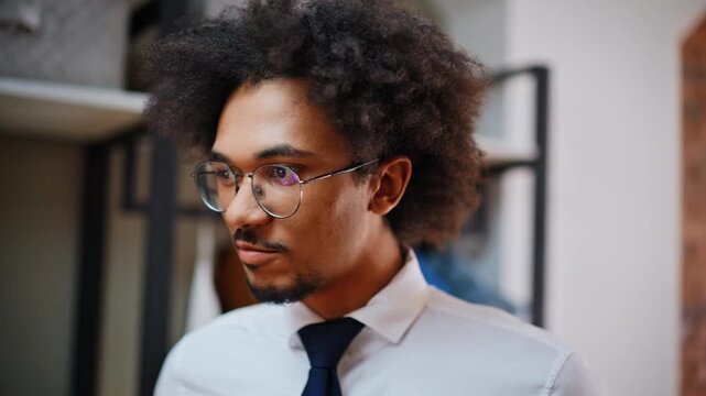 Mixed race office worker straightening necktie. Close up hands fixing blue tie.