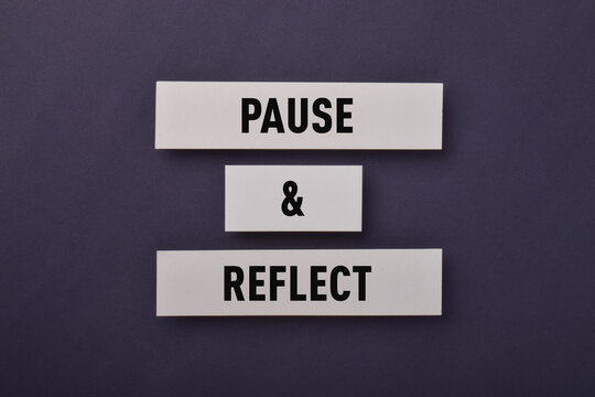 Conceptual image featuring pause and reflect signs, representing mindfulness, self reflection, careful thinking, contemplation, and thoughtful decision making.