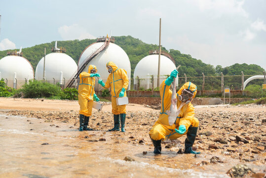 Environmental scientist wearing protective clothing, gloves, goggles and contaminated material from a polluted beach for environmental research