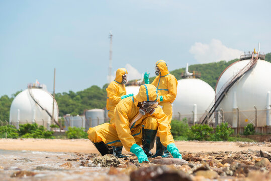 Environmental scientist wearing protective clothing, gloves, goggles and contaminated material from a polluted beach for environmental research