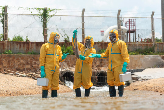 Environmental scientist wearing protective clothing, gloves, goggles and contaminated material from a polluted beach for environmental research