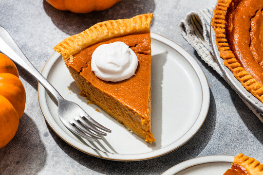 Homemade Sweet Thanksgiving Pumpkin Pie with Whipped Cream to Eat