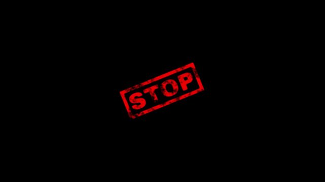 Red grunge rubber stamp with the word stop isolated on a black background