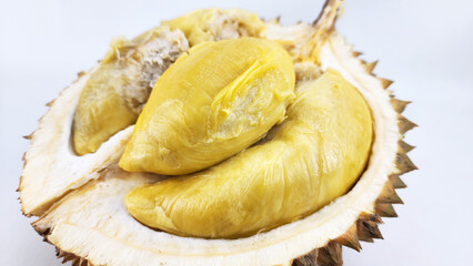 Close-up of local durian flesh with a sweet and bitter flavor profile and a soft texture, isolated on a white background. © PinkyEn