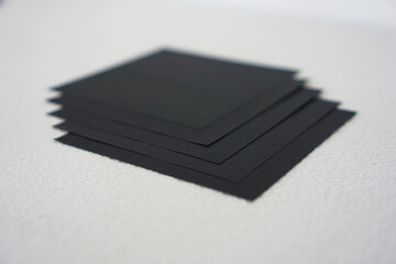 Fototapeta premium group of black origami paper is neatly arranged against a white background.
