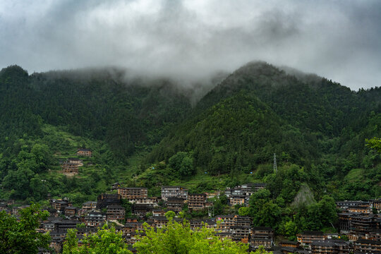Low clouds drifting over lush green mountains near Xijiang, Guizhou, China