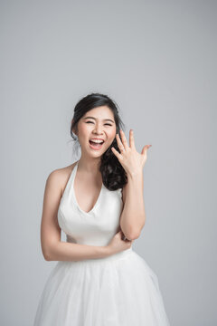 Happy Asian Woman Wearing White Dress Showing Engagement Ring