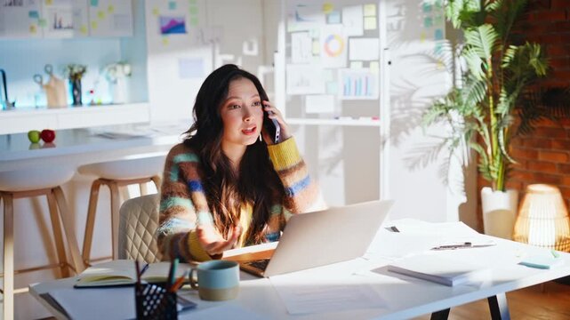 Business woman talking phone taking notes home office. Focused startup manager.