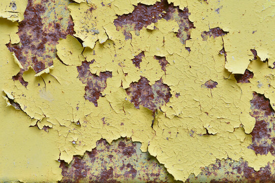 Cracked Peeling Yellow Paint on Old Rusty Metal Surface