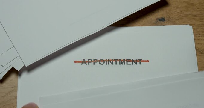 Close-up of the word Appointment crossed out on paper. Concept for canceled meeting, schedule change, rescheduling and unavailable booking.
