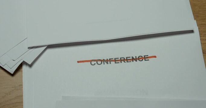 Close-up of the word Conference being crossed out with a red pen. Concept for cancelled conference, event cancellation, changed business plans and schedule disruption.