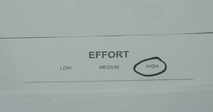 Close-up of high effort level circled on an assessment document. Concept for workload evaluation, project planning, difficulty and resource management.