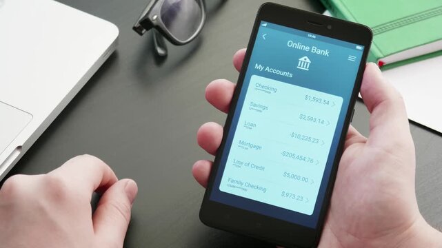 Person using mobile banking application upon smartphone, touching screen checking account balance and financial transactions