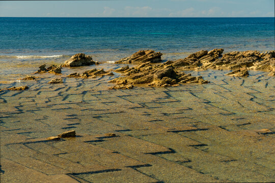 Italy, Sardinia, Oristano, Spiaggia di Is Arutas.  geometric shapes of sedimentary rock below the surface on the west coast of the island.