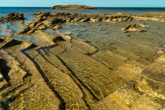 Italy, Sardinia, Oristano, Spiaggia di Is Arutas.  geometric shapes of sedimentary rock below the surface on the west coast of the island.