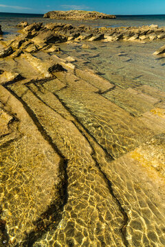 Italy, Sardinia, Oristano, Spiaggia di Is Arutas.  geometric shapes of sedimentary rock below the surface on the west coast of the island.