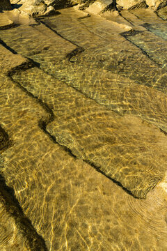 Italy, Sardinia, Oristano, Spiaggia di Is Arutas.  geometric shapes of sedimentary rock below the surface on the west coast of the island.
