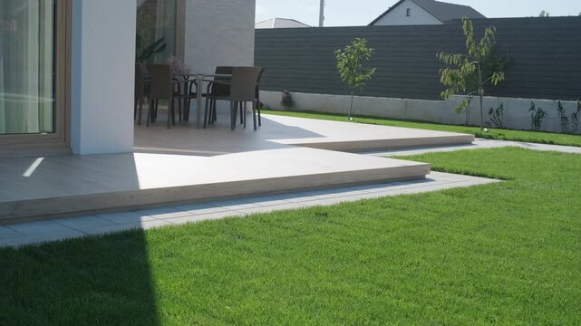 Modern single-story house with a flat roof and white facade.