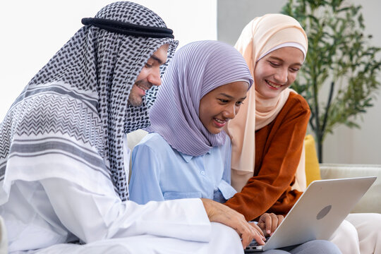 Middle east muslim parent are teaching their kid to doing homework and school assignment using laptop for online education, social media and ai tool related concept