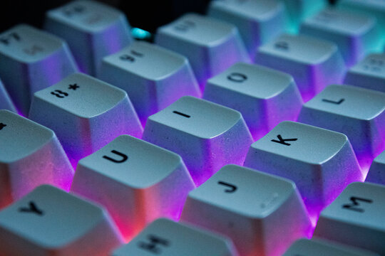 This is a close-up macro shot of a mechanical keyboard with bright backlighting