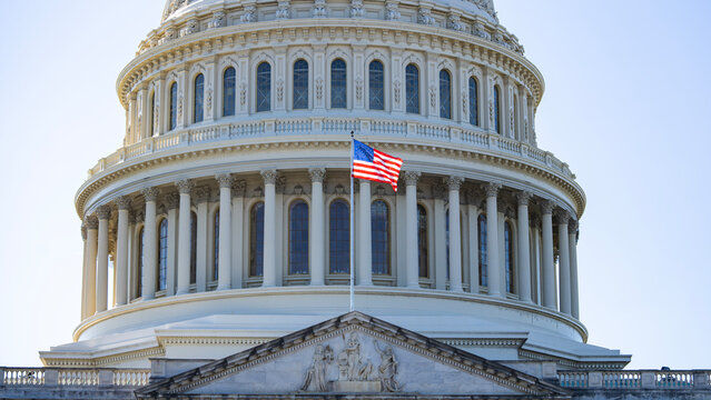 USA Flag near American Capitol dome. American flag, stars and stripes closeup. American flag in America on Flags Day. Flag at congress in Washington, USA.