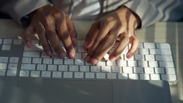 Close-up of hands typing on a computer keyboard at a modern workplace, representing digital work, online communication, data entry, productivity, technology, and everyday office tasks.