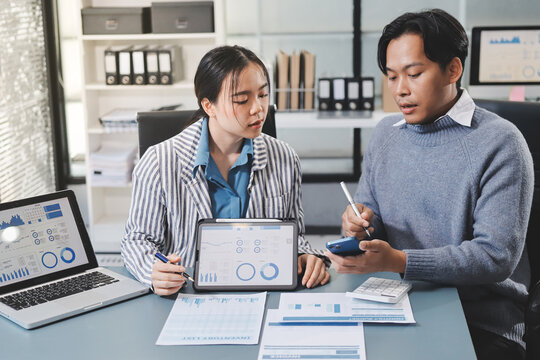 Business professional analyzing financial data on digital tablet dashboard with calculator and laptop, representing accounting software, ERP system integration, performance monitoring.