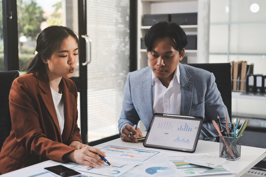 Business professional analyzing financial data on digital tablet dashboard with calculator and laptop, representing accounting software, ERP system integration, performance monitoring.