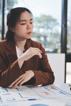 Business professional analyzing financial data on digital tablet dashboard with calculator and laptop, representing accounting software, ERP system integration, performance monitoring.