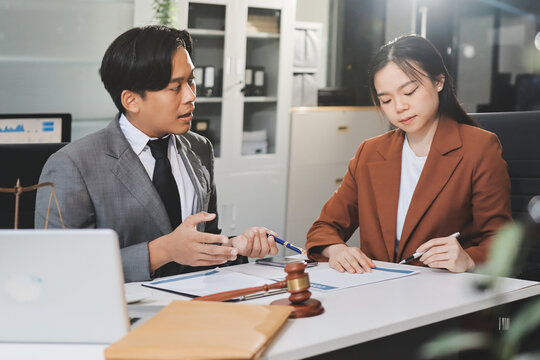 Businessmen or lawyers working together at a meeting, teamwork and partnership. Signing documents, contracts, checking details business agreement