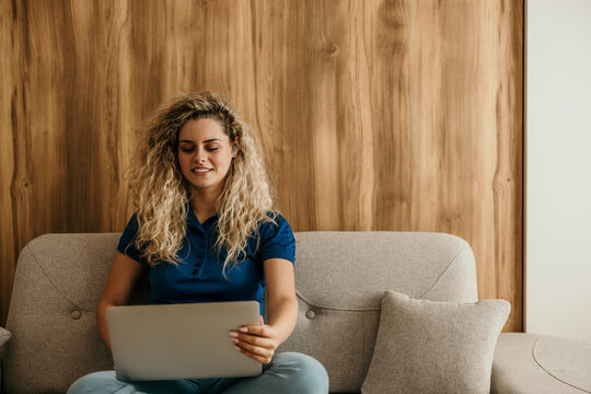 Woman working remotely on laptop at home