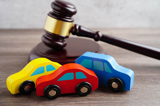 Car accident lawsuit and insurance, Judge hammer with car model.