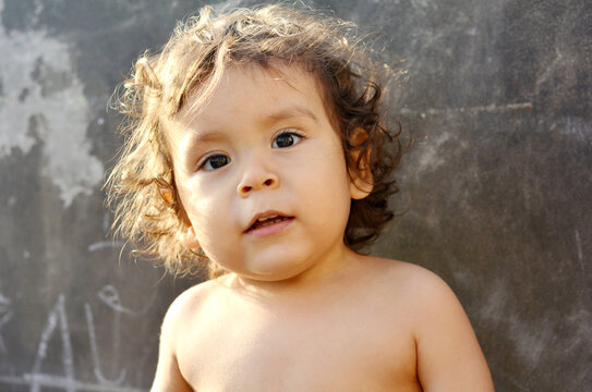 Latin toddler with slightly opened mouth.