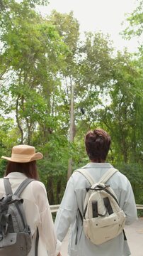 Young Couple Holding Hands and Walking on Park Road