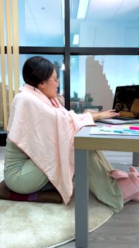 Asian Freelance Woman in Pajamas Working on Laptop from Home