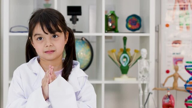 Young Girl in Lab Coat Sitting in Science Classroom