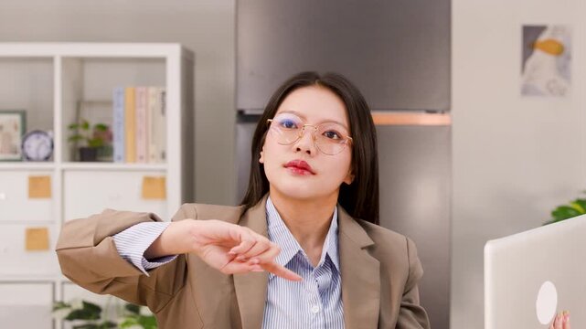 Asian Businesswoman Interacting with Virtual Screen in Modern Home Office
