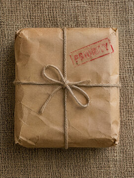 Vintage parcel wrapped in brown paper tied with string